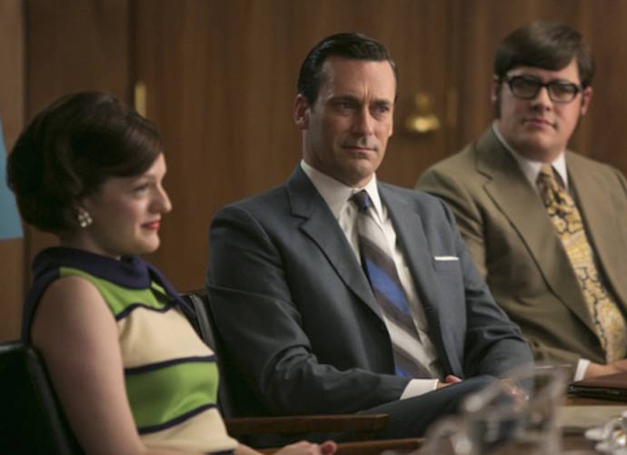 In this image released by AMC, Elisabeth Moss, from left, Jon Hamm and Rich Sommer appear in a scene from 
