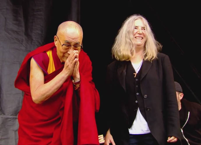 His Holiness The Dalai Lama and Patti Smith at the Glastonbury Festival. (Photo by rune hellestad/Getty Images)