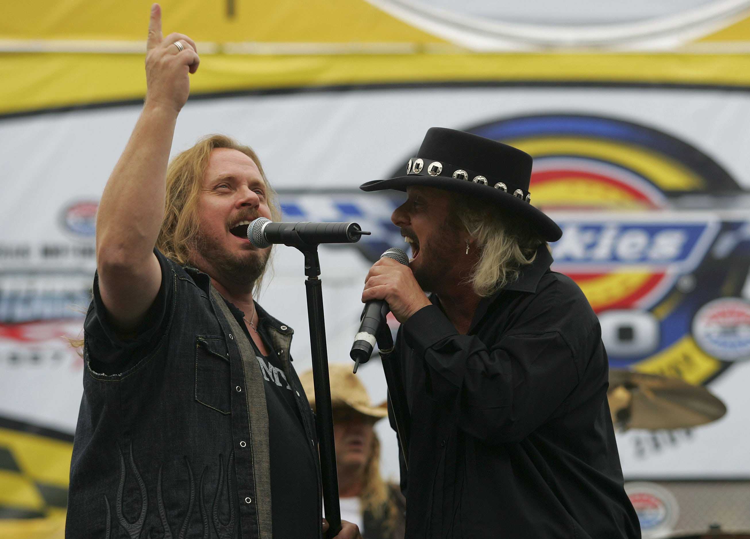 FORT WORTH, TX - NOVEMBER 05: (L-R) Jimmy Van Zant and Donnie Van Zant, of the group Van Zant, sing prior to the NASCAR Nextel Cup Series Dickies 500, on November 5, 2006 at Texas Motor Speedway in Fort Worth, Texas. (Photo by Todd Warshaw/Getty Images for NASCAR)