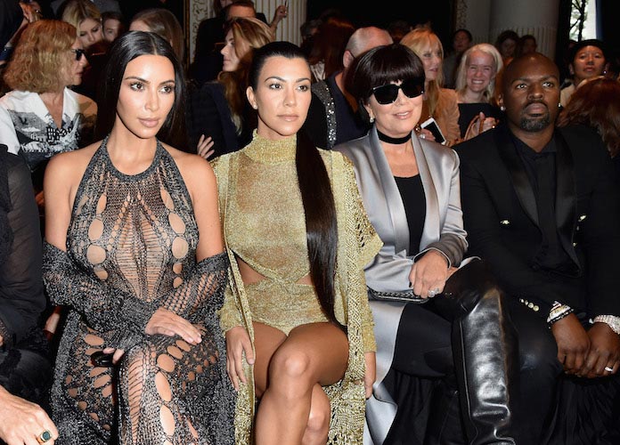 Kim Kardashian, Kourtney Kardashian, Kris Jenner and Corey Gamble front row at the Balmain show at Paris Fashion Week (Getty)