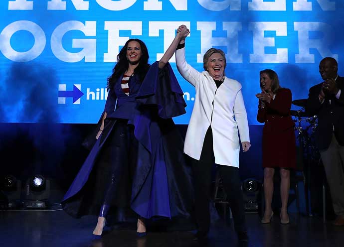 PHILADELPHIA, PA - NOVEMBER 05: Democratic presidential nominee former Secretary of State Hillary Clinton (R) raises her arms with recording artist Katy Perry (L) during a get-out-the-vote concert at the Mann Center for the Performing Arts on November 5, 2016 in Philadelphia, Pennsylvania. With three days to go until election day, Hillary Clinton is campaigning in Florida and Pennsylvania. (Photo by Justin Sullivan/Getty Images)
