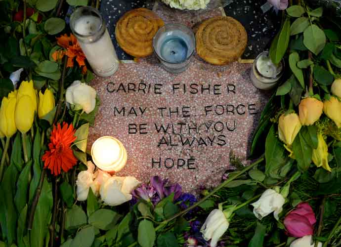HOLLYWOOD, CA - DECEMBER 29: Candles and flowers are placed on actress Carrie Fisher's makeshift star on The Hollywood Walk of Fame on December, 29 2016, in Hollywood, California. (Photo by Kevork Djansezian/Getty Images)