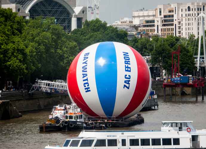 Giant beachball on the Thames at Westminster Bridge with wording Baywatch and Zac Efron down the sides