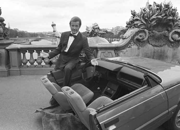 British actor Roger Moore on set of the James Bond movie 'A View to a Kill' with half a car during filming in Paris, France in August 1984. (Photo by Larry Ellis/Express/Getty Images)