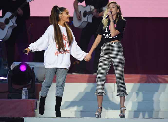 MANCHESTER, ENGLAND - JUNE 04: NO SALES, free for editorial use. In this handout provided by 'One Love Manchester' benefit concert (L) Ariana Grande and Miley Cyrus perform on stage on June 4, 2017 in Manchester, England. Donate at www.redcross.org.uk/love (Photo by Getty Images/Dave Hogan for One Love Manchester)