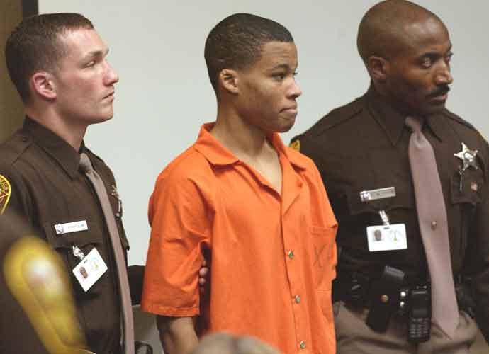 VIRGINIA BEACH, VA - OCTOBER 22: Sniper suspect Lee Boyd Malvo (C) is escorted by deputies as he is brought into court to be identified by a witness during the murder trial in courtroom 10 at the Virginia Beach Circuit Court October 22, 2003 in Virginia Beach, Virginia. Muhammad has decided not to represent himself in court and to turn his defense back to his attorneys. (Photo by Davis Turner-Pool/Getty Images)