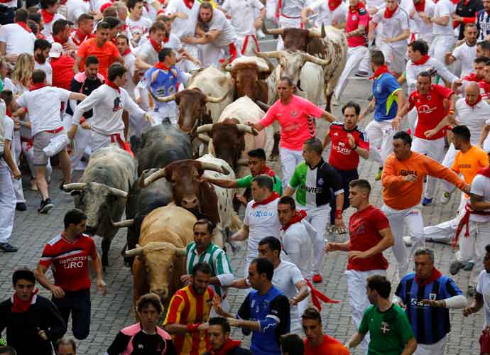 PAMPLONA, SPAIN - JULY 07: Revellers run with Cebada Gago's fighting bulls entering the bullring during the second day of the San Fermin Running of the Bulls festival on July 7, 2017 in Pamplona, Spain. The annual Fiesta de San Fermin, made famous by the 1926 novel of US writer Ernest Hemmingway entitled 'The Sun Also Rises', involves the daily running of the bulls through the historic heart of Pamplona to the bull ring. (Photo by Pablo Blazquez Dominguez/Getty Images)