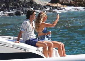 Jeremy Irvine and Lily James relaxing on a boat during the filming of 'Mamma Mia 2' in Croatia