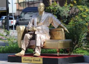 Street artist Plastic Jesus installs new sculpture of Harvey Weinstein casting couch statue just days before the big Hollywood Oscar night.