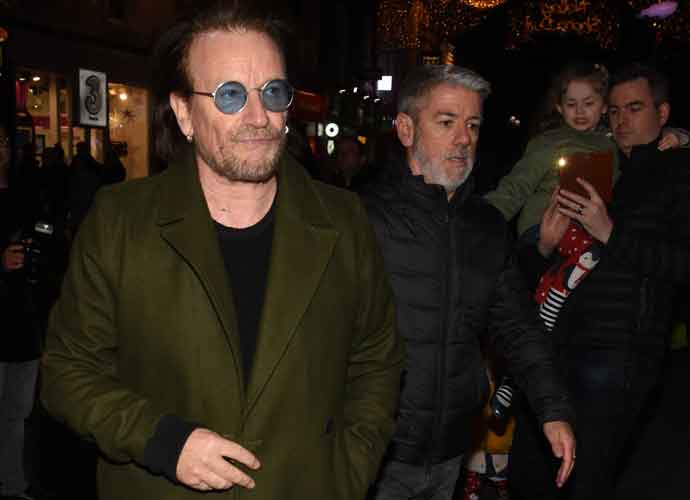 Bono & The Edge Perform At Christmas Eve Busk