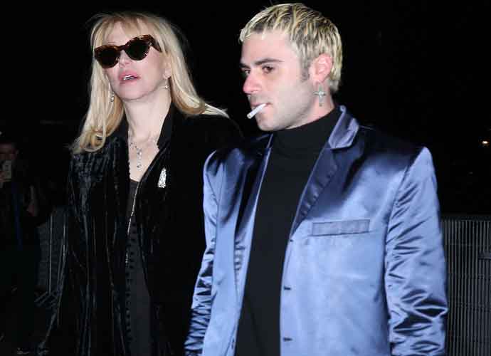 Courtney Love Attends Celine’s Menswear Show In Paris With Henry Levy