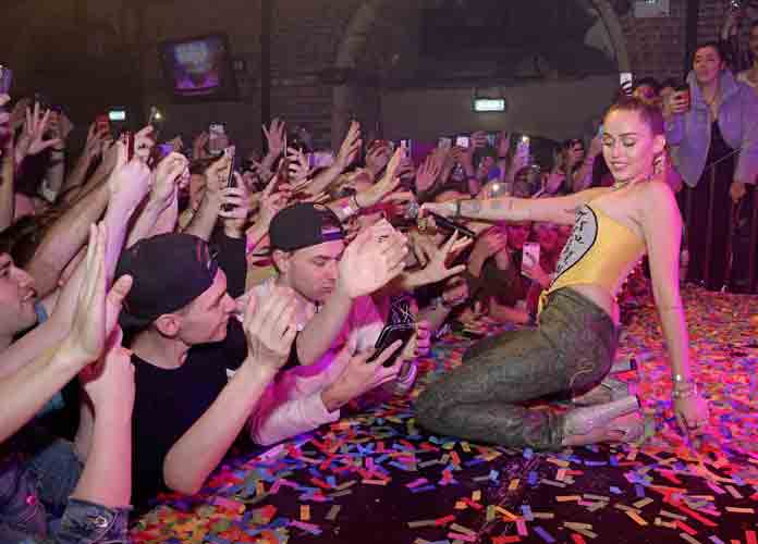 Caption : Miley Cyrus and Mark Ronson made a surprise appearance at G-A-Y to promote their new single 'Nothing Breaks Like A Heart'. With Ronson on the DJ decks and guitar, Cyrus performed the single as well as Wrecking Ball and a Todrick Hall number before paying homage to her RuPaul Drag Race friends with a death drop on stage. PersonInImage : Miley Cyrus Credit : Chris Jepson/WENN.com