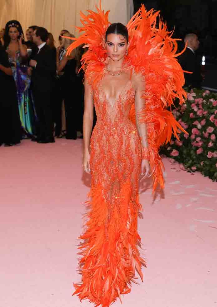 Versace - Kendall Jenner's #MetGala gown is paired with an orange-tone  feather trim created by attaching the plumes to the dress one by one by  hand. #AtelierVersace #MetCamp #VersaceCelebrities Photo by Greg