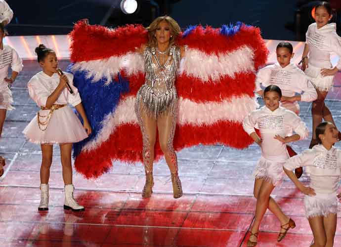 MIAMI, FLORIDA - FEBRUARY 02: Singer Jennifer Lopez and her daughter Emme Maribel Muñiz perform while a Puerto Rican flag is displayed on stage during the Pepsi Super Bowl LIV Halftime Show at Hard Rock Stadium on February 02, 2020 in Miami, Florida.
