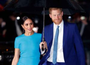 Prince Harry Holds Umbrella For Wife Meghan Markle At Endeavour Fund Awards (Image: Getty)