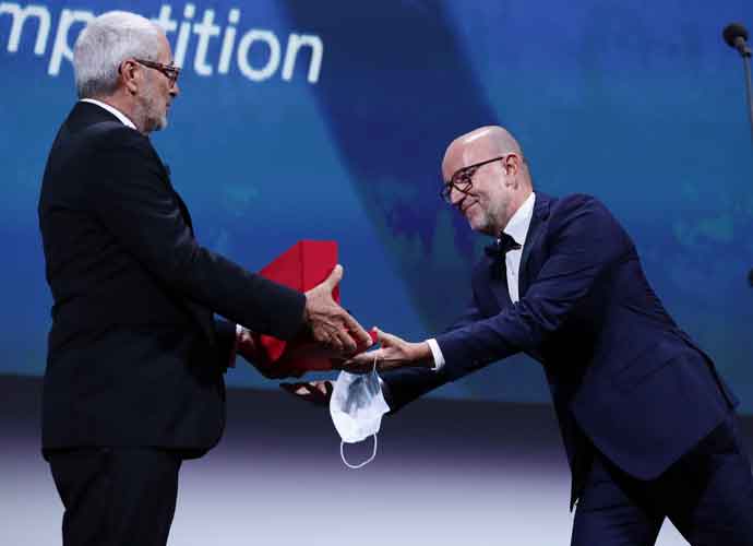 VENICE, ITALY - SEPTEMBER 12: Davide Romani (R) receives the Golden Lion for Best Film on behalf of US director Chloe Zhao for 