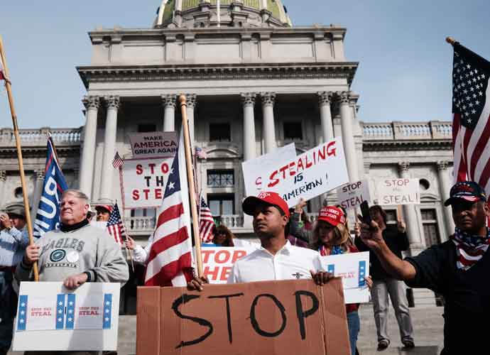HARRISBURG, PENNSYLVANIA - NOVEMBER 05: Dozens of people calling for stopping the vote count in Pennsylvania due to alleged fraud against President Donald Trump gather on the steps of the State Capital on November 05, 2020 in Harrisburg, Pennsylvania. The activists, many with flags and signs for Trump, have made allegations that votes are being stolen from the president as the race in Pennsylvania continues to tighten in Joe Biden's favor.