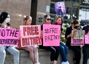 LOS ANGELES, CALIFORNIA - FEBRUARY 11: Supporters hold signs at the hearing for the Britney Spears Conservatorship at Stanley Mosk Courthouse on February 11, 2021 in Los Angeles, California. (Photo by Frazer Harrison/Getty Images)