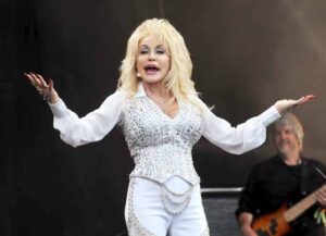 GLASTONBURY, ENGLAND - JUNE 29: Dolly Parton performs on the Pyramid stage during day three of the Glastonbury Festival at Worthy Farm in Pilton on June 29, 2014 in Glastonbury, England. Tickets to the event, which is now in its 44th year, sold out in minutes even before any of the headline acts had been confirmed. The festival, which started in 1970 when several hundred hippies paid £1, now attracts more than 175,000 people. (Photo by Jim Dyson/Getty Images)