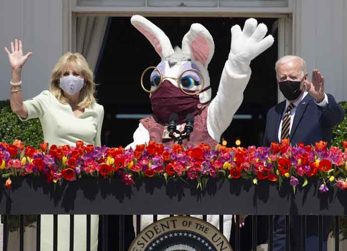 U.S. President Joe Biden, right, and First Lady Jill Biden wave beside a costumed Easter bunny from the Truman Balcony of the White House in Washington, D.C., U.S., on Monday, April 5, 2021. The Biden administration is aiming to corral overwhelming public support for its $2.25 trillion infrastructure plan, targeting Republican voters, independents, mayors, governors and local politicians to counter opposition from GOP lawmakers. Photographer: Michael Reynolds/EPA/Bloomberg via Getty Images