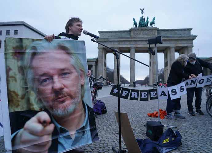 BERLIN, GERMANY - APRIL 01: Protesters demand freedom for WikiLeaks founder Julian Assange at the Brandenburg Gate on April 01, 2021 in Berlin, Germany. Assange is currently in prison in the United Kingdom. The United States is seeking his extradition. (Photo by Sean Gallup/Getty Images)