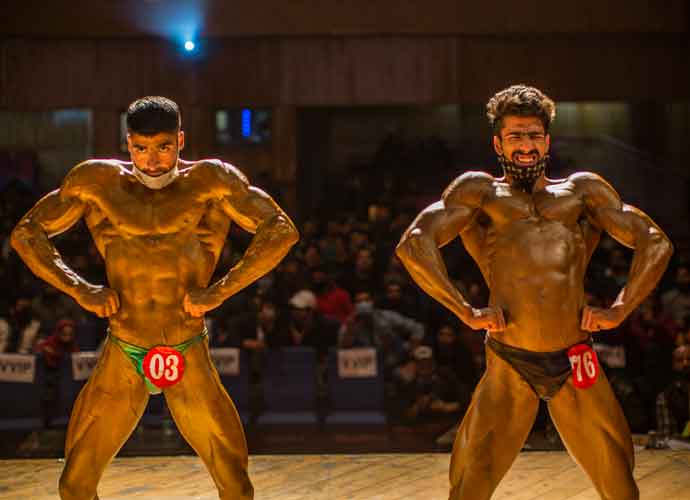 SRINAGAR, KASHMIR, INDIA - APRIL 04: Amid the pandemic bodybuilders strike a pose during the Mr. Srinagar Bodybuilding Competition organized by Jammu and Kashmir Bodybuilding Association, on April 04, 2021 in Srinagar, the summer capital of Indian administered Kashmir, India. At a time when India is in the grip of the second wave of Coronavirus pandemic (COVID-19), Srinagar's many top bodybuilders took part in an event, health experts have again urged people to follow Covid guidelines. The championship was canceled last year but organizers went ahead with the event this year amid the pandemic. Kashmiri youths are taking interest in bodybuilding, making it a popular sport in Kashmir. Bodybuilders said sports can help ease the psychological trauma of decades-old conflict in Kashmir Many major sporting events across the world have either been postponed or canceled. As many as 93,249 more people tested positive for Covid-19 in the last 24 hours as the second wave of the infection rages across the country said the Union health ministry on Sunday. With more than 11.35 million recoveries since the beginning of the pandemic and 165,132 total deaths have been recorded. (Photo by Yawar Nazir/Getty Images)