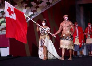 TOKYO, JAPAN - JULY 23: Flag bearers Malia Paseka and Pita Taufatofua of Team Tonga lead their team out during the Opening Ceremony of the Tokyo 2020 Olympic Games at Olympic Stadium on July 23, 2021 in Tokyo, Japan. (Photo by Hannah McKay - Pool/Getty Images)