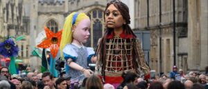 OXFORD, ENGLAND - OCTOBER 26: "Alice" from the Alice in Wonderland story and "Little Amal" are seen on October 26, 2021as they walk through the cectre of Oxford, England. Little Amal, the 3.5 metre-tall puppet representing a migrant Syrian girl, visited Oxford while on her 8,000km journey across Europe. This year marks the 150th anniversary of Lewis Carroll's "Through the Looking-Glass," which was celebrated by Oxford's Story Museum with the creation of a giant Alice puppet. (Photo by Leon Neal/Getty Images)