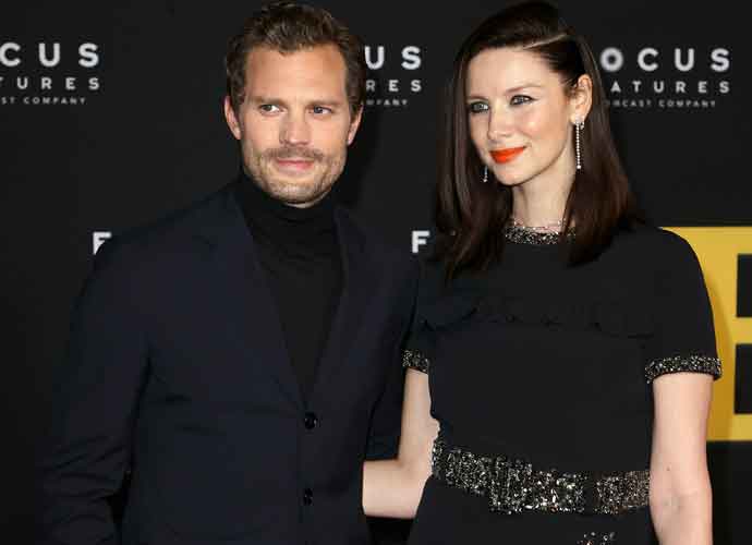 LOS ANGELES, CALIFORNIA - NOVEMBER 08: (L-R) Jamie Dornan and Caitriona Balfe attend the premiere of Focus Features' 