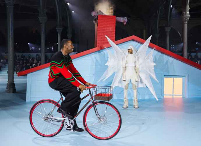 ARIS, FRANCE - JANUARY 20: (EDITORIAL USE ONLY - For No Tyler, The Creator rides a bike as a model walks the runway during the Louis Vuitton Menswear Fall/Winter 2022-2023 show as part of Paris Fashion Week on January 20, 2022 in Paris, France. (Photo by Victor Boyko/Getty Images)