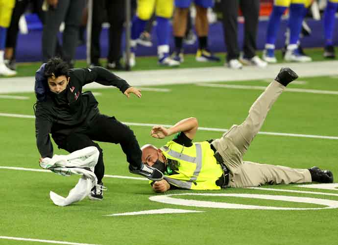 INGLEWOOD, CALIFORNIA - FEBRUARY 13: Security tackles a fan who ran on the field during Super Bowl LVI between the Cincinnati Bengals and the Los Angeles Rams at SoFi Stadium on February 13, 2022 in Inglewood, California. (Photo by Rob Carr/Getty Images)