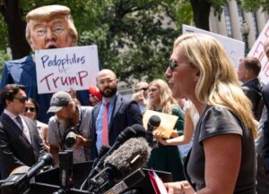 WASHINGTON, DC - JULY 27: Protestors hold an effigy of former President Donald Trump as Rep. Marjorie Taylor Greene (R-GA) speaks during a news conference outside the U.S. Department of Justice on July 27, 2021 in Washington, DC. The group of far-right conservatives held a news conference to demand answers from Attorney General Merrick Garland on the status of January 6 prisoners. (Photo by Drew Angerer/Getty Images)