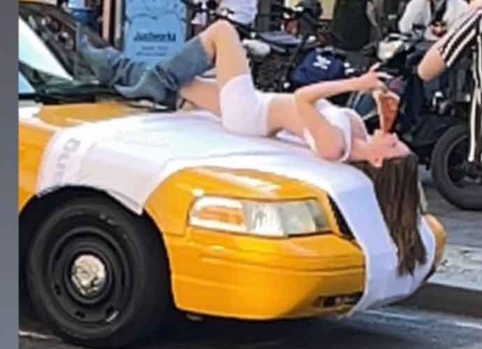 Julia Fox in bra and boxers stands on cab in NYC (Image: Twitter)