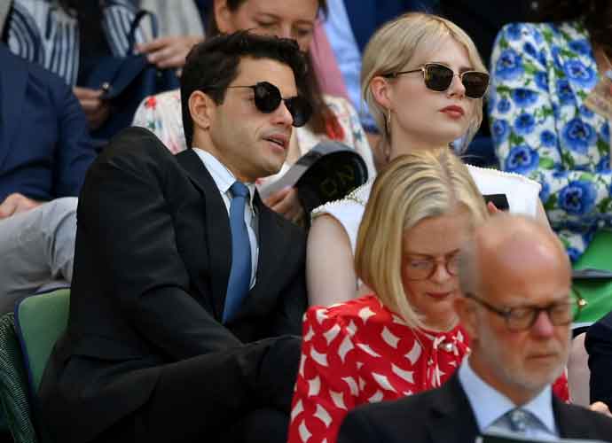 LONDON, ENGLAND - JULY 08: Actor Rami Malek and Lucy Boynton look on prior to play commencing on Centre Court on day twelve of The Championships Wimbledon 2022 at All England Lawn Tennis and Croquet Club on July 08, 2022 in London, England. (Photo by Shaun Botterill/Getty Images)