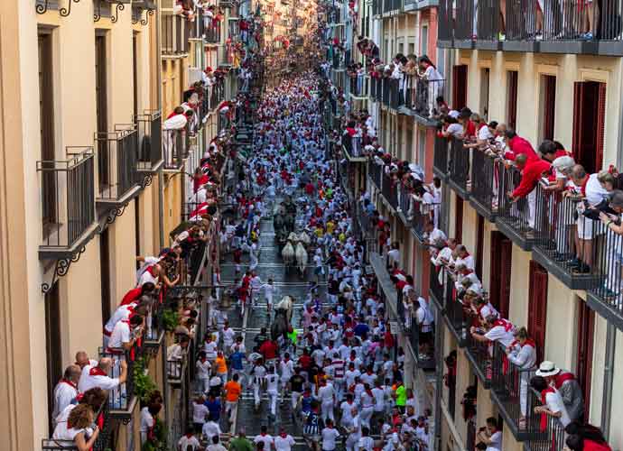 PAMPLONA, SPAIN - JULY 09: Revellers run with Jose Escolar Gil's fighting bulls along Calle Estafeta during the forth day of the San Fermin Running of the Bulls festival on July 09, 2022 in Pamplona, Spain. The iconic Spanish festival has resumed in earnest this year after being twice cancelled due to Covid-19. (Photo by Pablo Blazquez Dominguez/Getty Images)