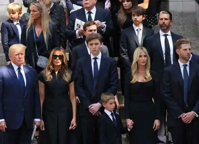 NEW YORK, NEW YORK - JULY 20: former U.S. President Donald Trump and his wife Melania Trump along with their son Barron Trump and Ivanka Trump, Eric Trump and Donald Trump Jr. and their children watch as the casket of Ivana Trump is put in a hearse outside of St. Vincent Ferrer Roman Catholic Church during her funeral on July 20, 2022 in New York City. Trump, the first wife of former U.S. President Donald Trump, died at the age of 73 after a fall down the stairs of her Manhattan home. (Photo by Michael M. Santiago/Getty Images)