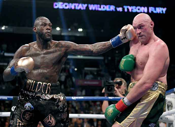LOS ANGELES, CA - DECEMBER 01: Deontay Wilder punches Tyson Fury in the ninth round fighting to a draw during the WBC Heavyweight Championship at Staples Center on December 1, 2018 in Los Angeles, California.