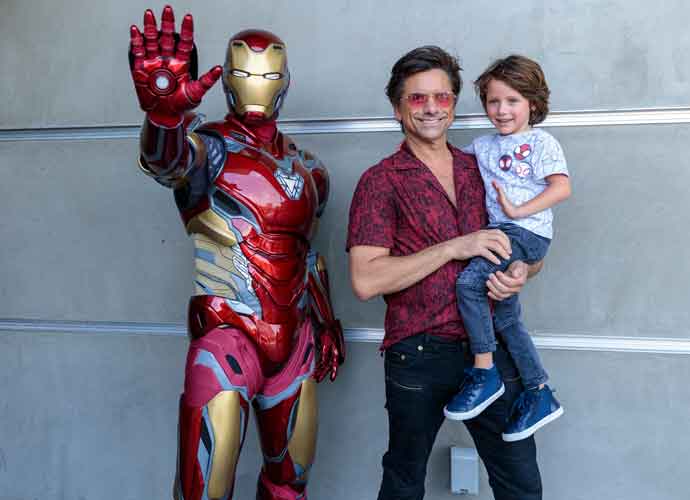 ANAHEIM, CA - AUGUST 01: In this handout photo provided by Disney Resorts, John Stamos and his son pose with Iron Man at Disney California Adventure Park on August 01, 2022 in Anaheim, California. The second season of 