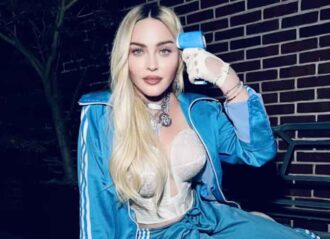 Madonna poses in blue tracksuit checking her temperature in bizarre new photos (Image: Instagram)