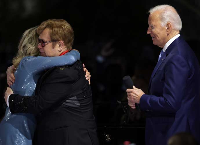 WASHINGTON, DC - SEPTEMBER 23: British singer-songwriter Sir Elton John (2nd L) hugs U.S. first lady Jill Biden (L) after he was presented with the National Humanities Medal by President Joe Biden (R) during an event at the South Lawn of the White House on September 23, 2022 in Washington, DC. President Joe Biden and first lady Jill Biden hosted the event titled “A Night When Hope and History Rhyme,” to “celebrate the unifying and healing power of music, commend the life and work of Sir Elton John, and honor the everyday history-makers in the audience, including teachers, nurses, frontline workers, mental health advocates, students, LGBTQ+ advocates and more.” (Photo by Alex Wong/Getty Images)