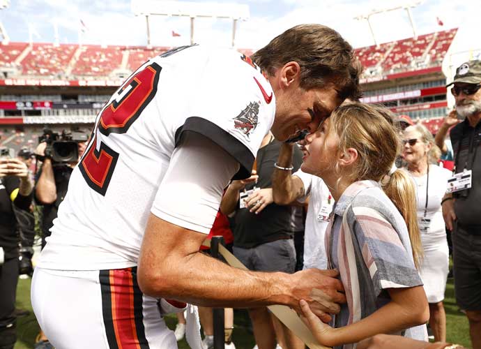 TAMPA, FLORIDA - SEPTEMBER 25: Tom Brady #12 of the Tampa Bay Buccaneers talks with his daughter Vivian on the sidelines prior to the game against the Green Bay Packers at Raymond James Stadium on September 25, 2022 in Tampa, Florida. (Photo by Douglas P. DeFelice/Getty Images)