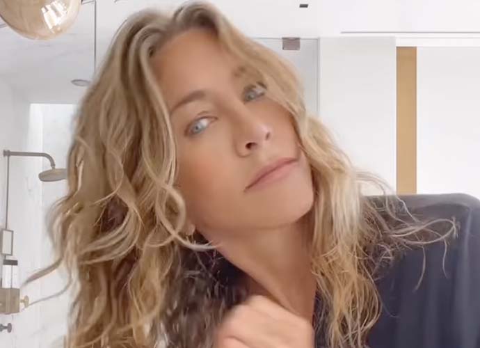 Jennifer Aniston demonstrates new hair product (Image: Instagram)