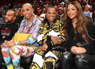 ATLANTA, GEORGIA - NOVEMBER 27: Kim Blackwell, Kandi Burruss, and Riley Burruss attend the game between the Miami Heat and the Atlanta Hawks at State Farm Arena on November 27, 2022 in Atlanta, Georgia. (Photo by Paras Griffin/Getty Images)