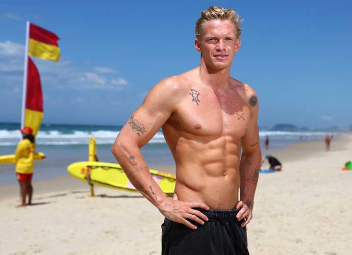 GOLD COAST, AUSTRALIA - MARCH 15: Cody Simpson poses during a beach safety demonstration alongside Surf Life Saving Australia lifesavers on March 15, 2023 in Gold Coast, Australia. (Photo by Chris Hyde/Getty Images)