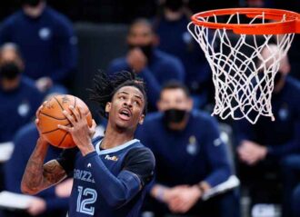 PORTLAND, OREGON - APRIL 25: Ja Morant #12 of the Memphis Grizzlies dunks against the Portland Trail Blazers during the third quarter at Moda Center on April 25, 2021 in Portland, Oregon. (Photo by Steph Chambers/Getty Images)