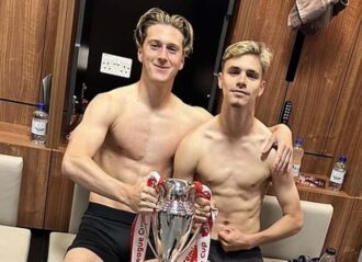 Romeo Beckham. right, poses shirtless with Premier League Cup trophy (Image: Instagram)