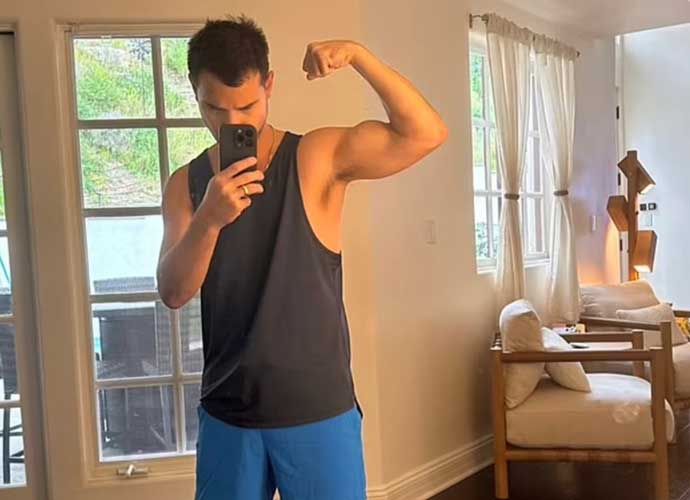 Taylor Lautner flexes bicep after being mocked on social media (Image: Instagram)