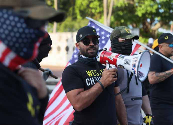 MIAMI, FLORIDA - MAY 25: Enrique Tarrio (C), leader of the Proud Boys, uses a megaphone while counter-protesting people gathered at the Torch of Friendship to commemorate the one year anniversary of the killing of George Floyd on May 25, 2021 in Miami, Florida. Mr. Tarrio lead a group to the area to express their support of police officers. Floyd's murder by Minneapolis police officer Derek Chauvin sparked global protest and continues to spur the Black Lives Matter movement. (Photo by Joe Raedle/Getty Images) Proud Boys’ Leader Enrique Tarrio To Remain Behind Bars While Facing Jan.6 Charges by Tara CumberbatchMarch 18, 2022, 1:02 amDaily Digest, Homepage Slider, News, News Feed Enrique Tarrio, the 38-year old leader of the Proud Boys extremist group, appeared in Miami federal court Tuesday. A magistrate judge ordered that he remain behind bars before his trial on charges of planning the attack on the Capitol. Magistrate Judge Lauren Louis said, “he’s a danger to the community is rebutted,” after rejecting a plea by Tarrio’s defense attorney to release him on $1.25 million secured by his family members in Miami. Tarrio will be transferred to Washington, D.C. to face indictment, after being in custody at the Miami Federal Detention Center. Although Tarrio wasn’t present on the day of the attack, Justice Department prosecutors said in its filing, “he directed fellow Proud Boy members in encrypted chat room messages to storm Congress and stop Joe Biden’s victory.” Nayib Hassan, Tarrio’s defense attorney, argues that Tarrio is not a violent person and did not order anyone to storm the Capitol building, hurt officers or damage government property. Subscribe! A week of political news in your in-box. We find the news you need to know, so you don't have to. According to the indictment before the Jan. 6 attack, Tarrio met with the founder of another extremist group, the Oath Keepers, discussing plans to target Congress. Almost 800 people, many from Florida, have been arrested for involvement in the insurrection (Image: Getty)
