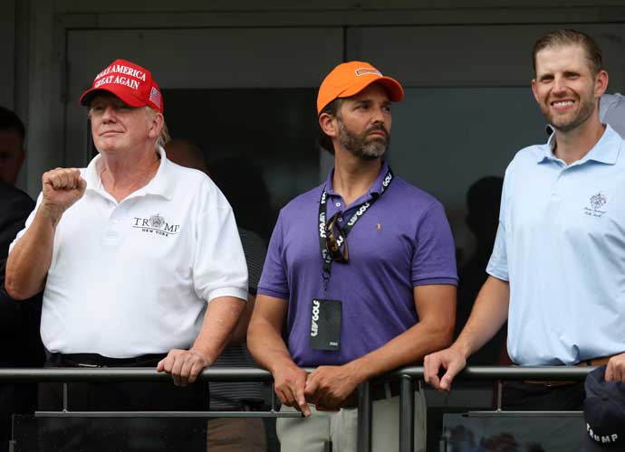 BEDMINSTER, NEW JERSEY - JULY 31: Former U.S. President Donald Trump, Donald Trump Jr. and Eric Trump watch play on the 16th hole during day three of the LIV Golf Invitational - Bedminster at Trump National Golf Club Bedminster on July 31, 2022 in Bedminster, New Jersey. (Photo by Jonathan Ferrey/LIV Golf via Getty Images)