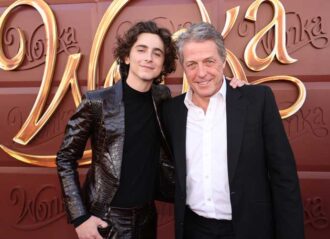 LOS ANGELES, CALIFORNIA - DECEMBER 10: Timothée Chalamet (L) and Hugh Grant attend the Los Angeles Premiere of Warner Bros. "Wonka" at Regency Village Theatre on December 10, 2023 in Los Angeles, California. (Photo by Eric Charbonneau/Getty Images for Warner Bros.)